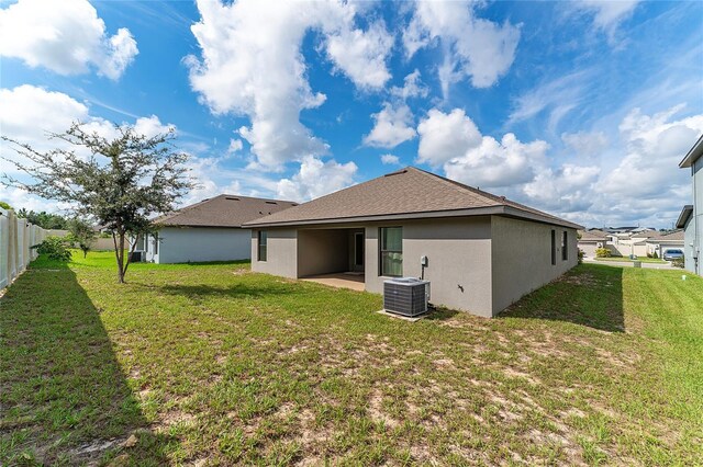 220 Bergamot Loop, Davenport, FL 33837 - rear view of property featuring stucco siding, a patio area, and a shingled roof