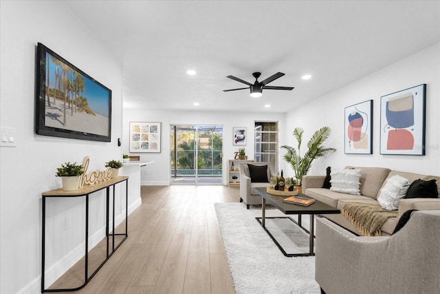 living room featuring light wood-type flooring and ceiling fan