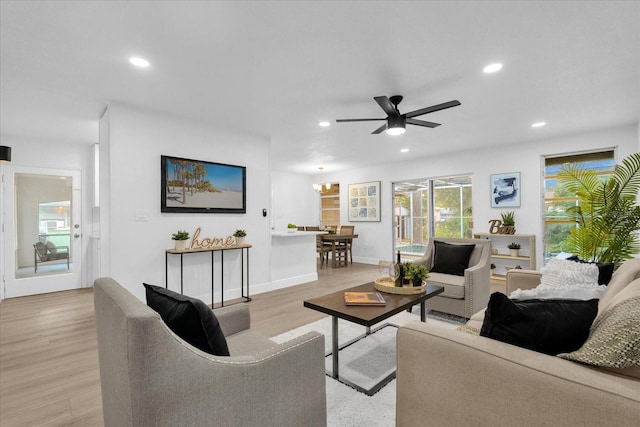 living room with ceiling fan and light hardwood / wood-style floors