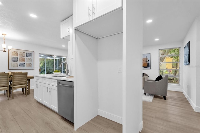 kitchen with light hardwood / wood-style floors, dishwasher, sink, and plenty of natural light