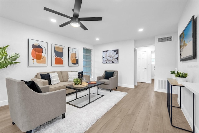 living room with ceiling fan, light hardwood / wood-style flooring, and a healthy amount of sunlight