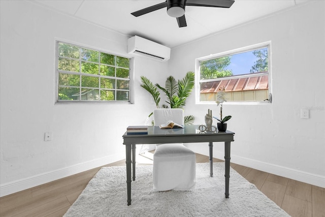 office area featuring ceiling fan, a wall unit AC, hardwood / wood-style flooring, and a healthy amount of sunlight