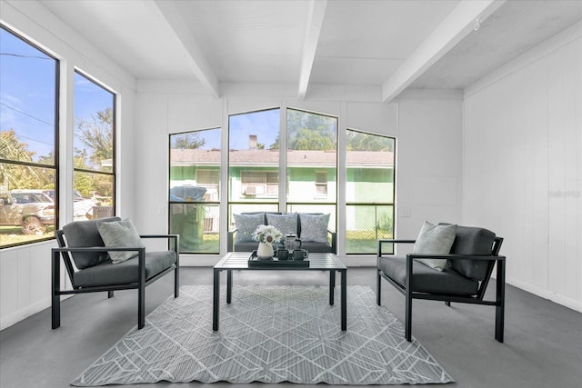 sunroom featuring beam ceiling and plenty of natural light