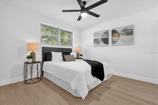 bedroom with wood-type flooring and ceiling fan