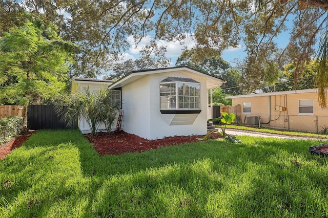 view of side of home with a lawn