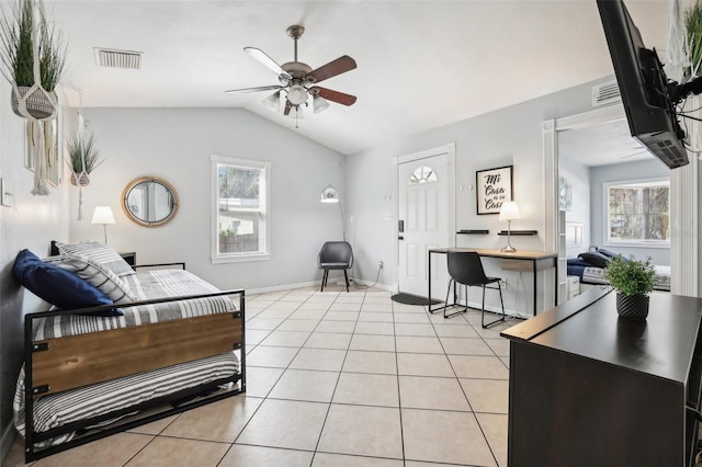 living room featuring vaulted ceiling, ceiling fan, and light tile patterned floors