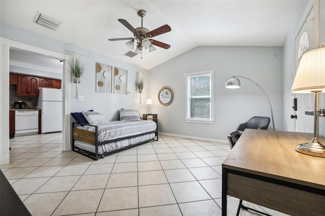 bedroom with ceiling fan, lofted ceiling, white refrigerator, and light tile patterned floors