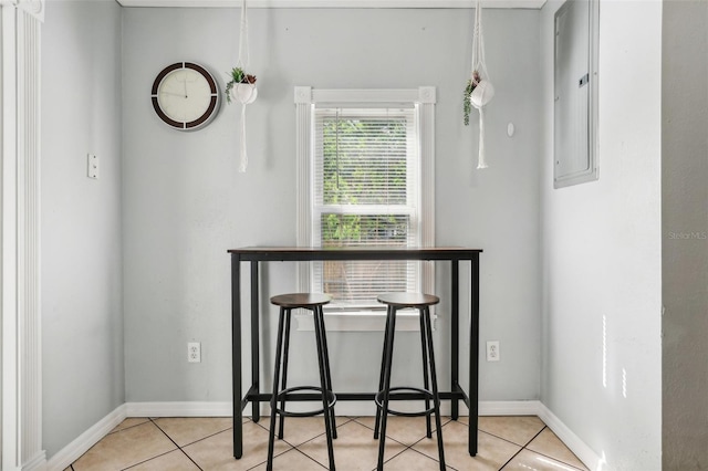 dining room featuring electric panel and light tile patterned floors