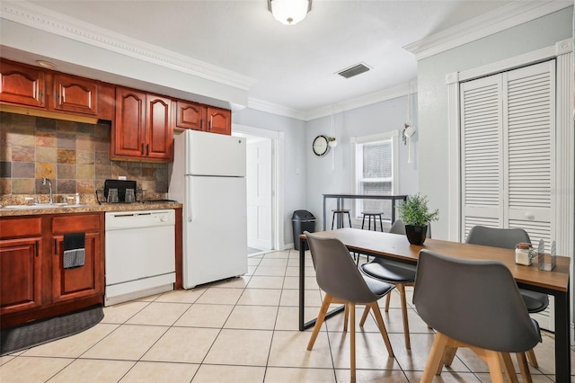 kitchen with light tile patterned flooring, sink, backsplash, white appliances, and crown molding