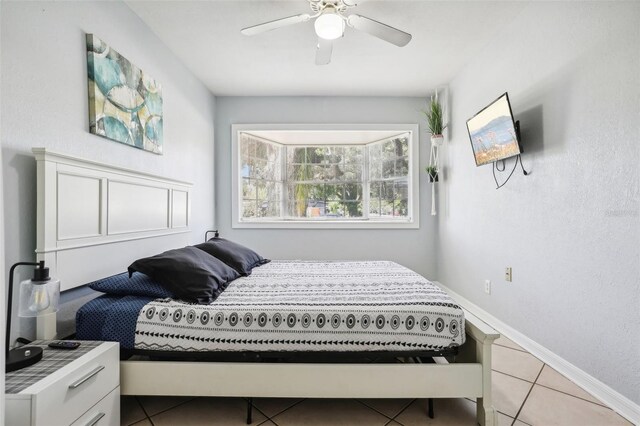 tiled bedroom with ceiling fan