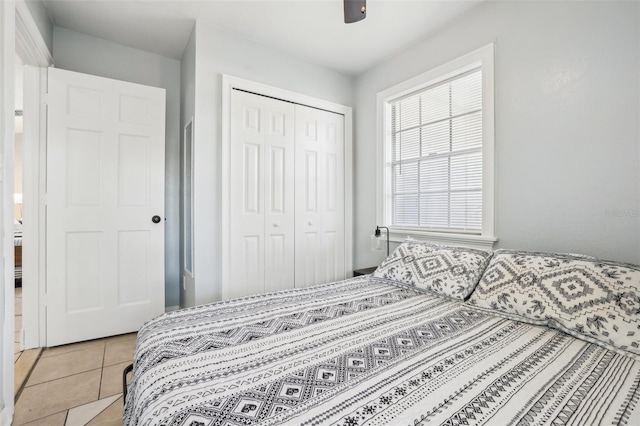 tiled bedroom with a closet and ceiling fan