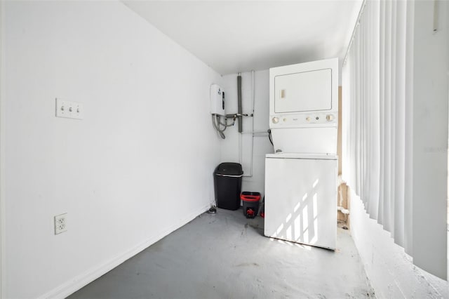 clothes washing area with stacked washer / dryer