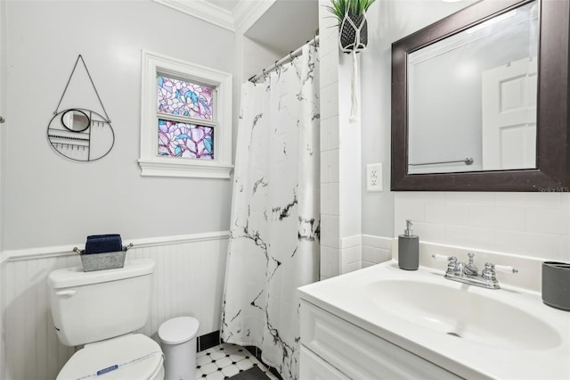 bathroom with walk in shower, ornamental molding, vanity, and toilet