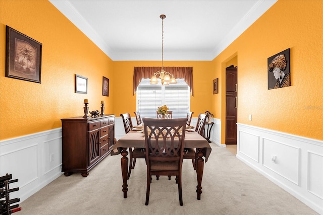 carpeted dining area featuring a chandelier