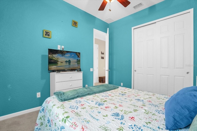 carpeted bedroom with ceiling fan and a closet