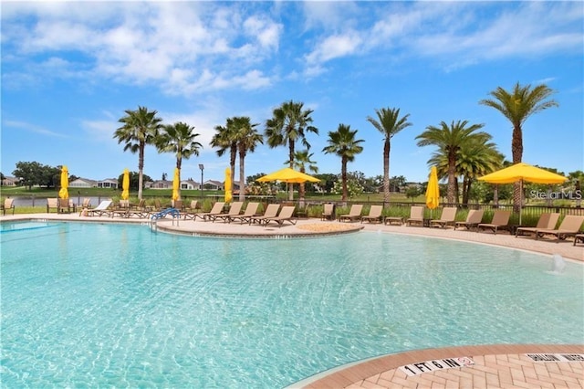 pool with a patio and fence