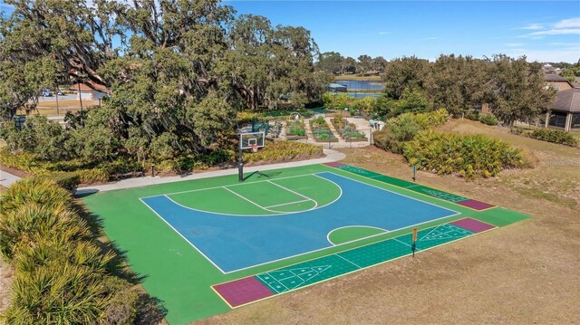 view of sport court featuring community basketball court and a water view