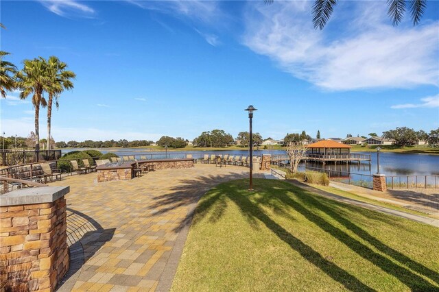 exterior space with a water view and a patio
