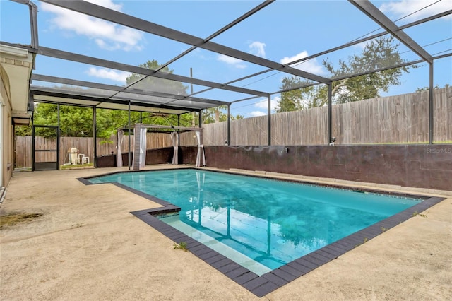 view of swimming pool featuring a lanai and a patio area