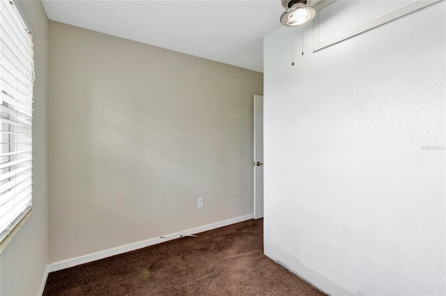 empty room with dark colored carpet