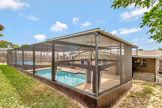 view of swimming pool featuring a lanai