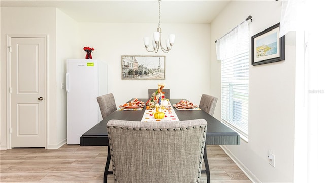 dining room featuring an inviting chandelier and light hardwood / wood-style flooring