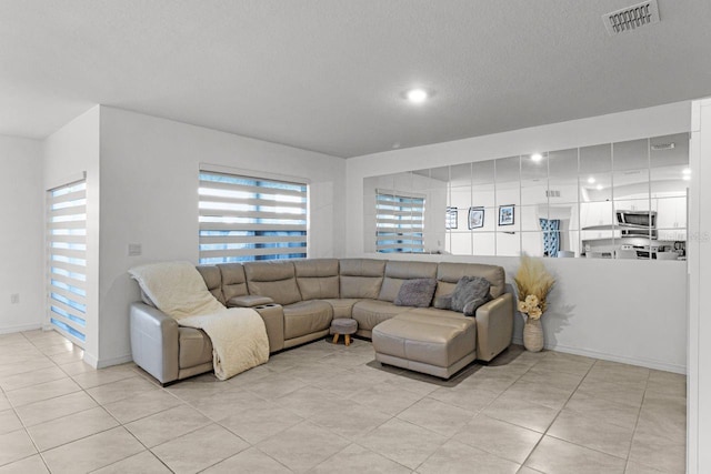 tiled living room with a textured ceiling