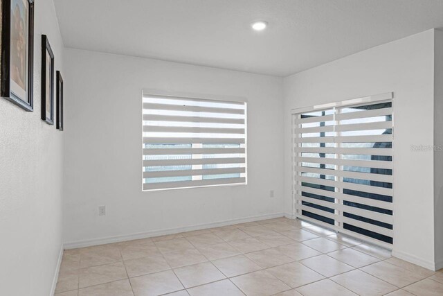 unfurnished room featuring light tile patterned flooring