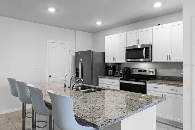 kitchen featuring appliances with stainless steel finishes, sink, and an island with sink