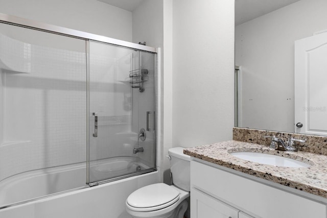 full bathroom with vanity, toilet, and combined bath / shower with glass door