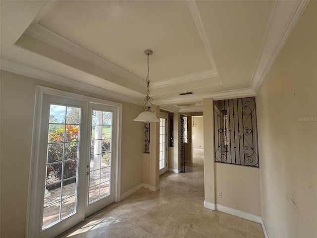 interior space with a tray ceiling and crown molding