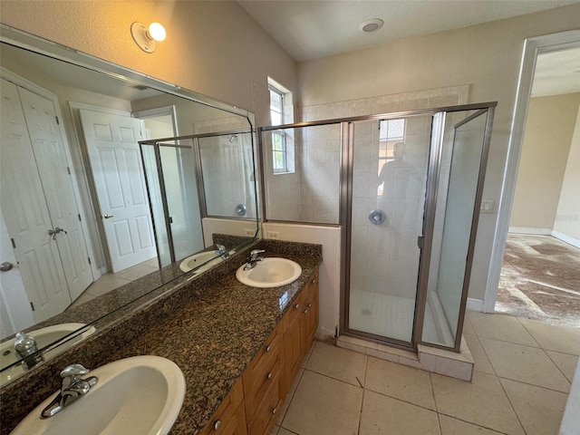 bathroom with vanity, a shower with shower door, and tile patterned flooring