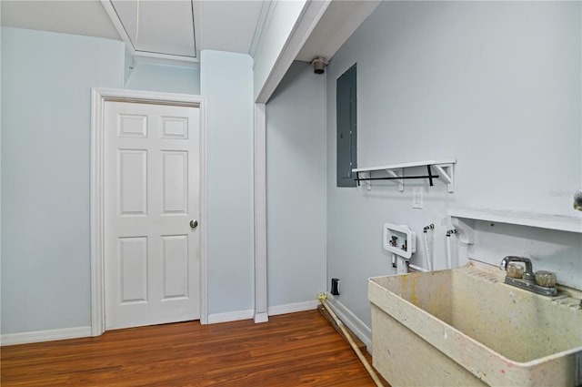 washroom with dark wood finished floors, hookup for a washing machine, a sink, laundry area, and electric panel