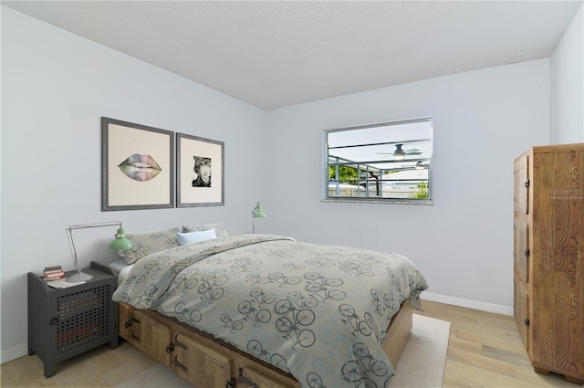 bedroom with light wood-style floors and baseboards