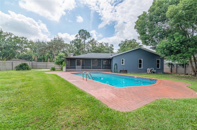 view of pool with a patio, a fenced backyard, a sunroom, a yard, and a fenced in pool