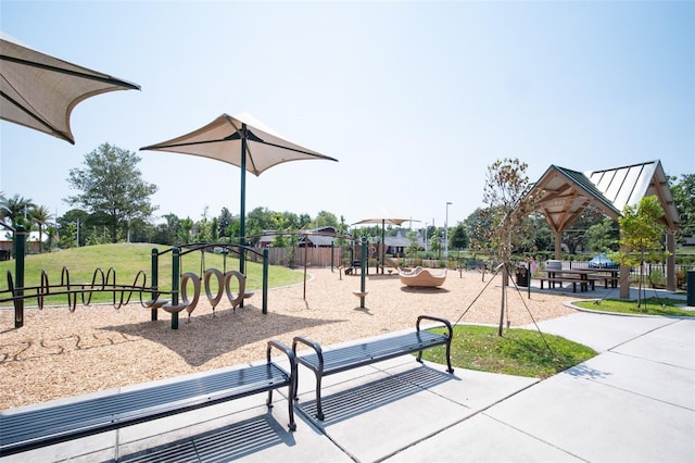 community jungle gym featuring a lawn and fence