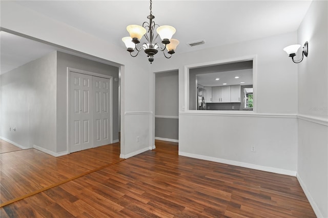 unfurnished dining area with baseboards, visible vents, dark wood-style floors, a chandelier, and recessed lighting