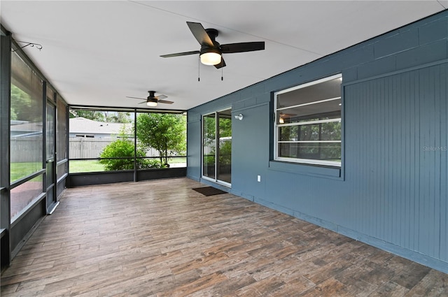 unfurnished sunroom with a healthy amount of sunlight and ceiling fan