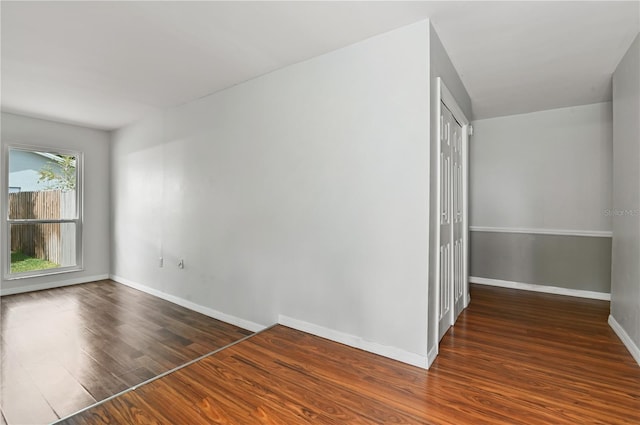 empty room with wood finished floors and baseboards