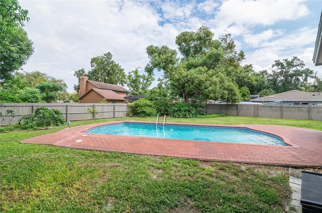 view of pool with a fenced backyard, a fenced in pool, and a yard