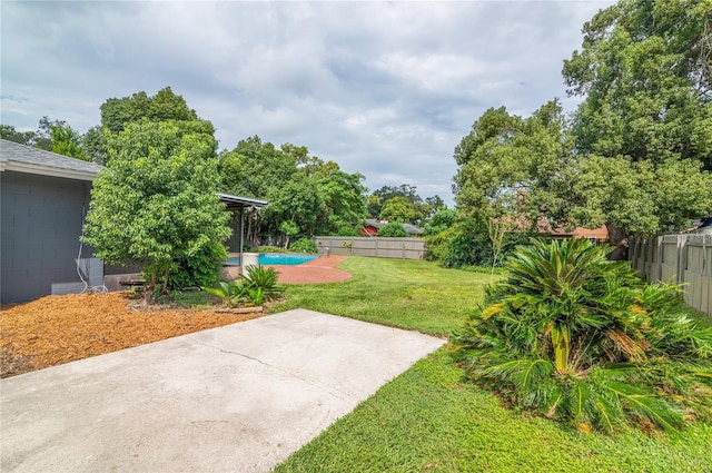 view of yard with a patio area, a fenced backyard, and a fenced in pool