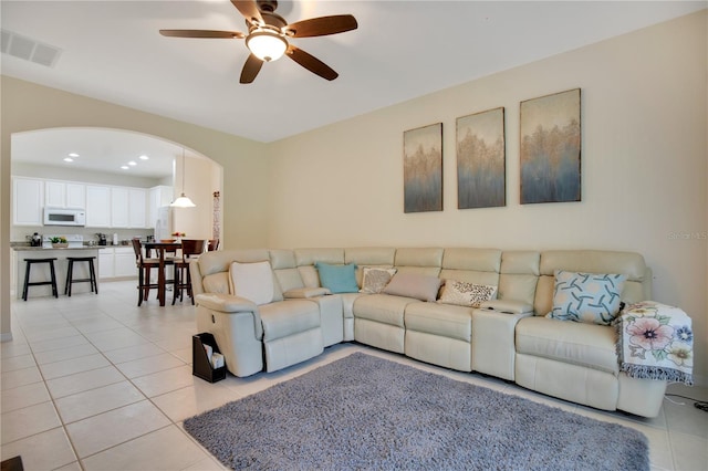 tiled living room with ceiling fan