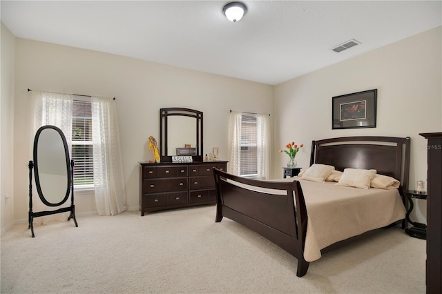 1033 Hacienda Cir, Kissimmee, FL 34741 - bedroom featuring visible vents, baseboards, multiple windows, and light colored carpet
