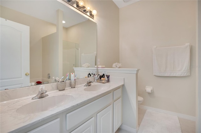 bathroom featuring tile patterned floors, a shower with shower door, vanity, and toilet