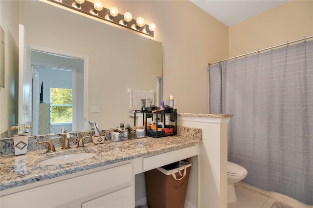 bathroom with tile patterned floors, vanity, and toilet