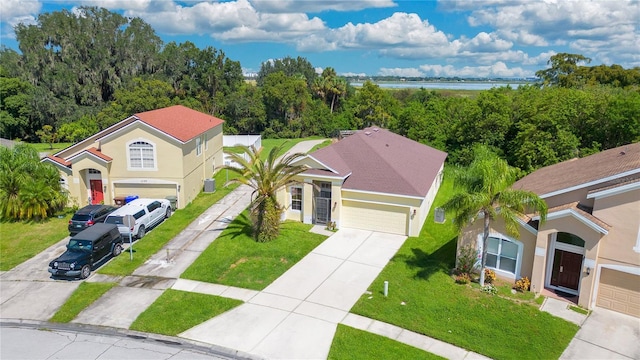1033 Hacienda Cir, Kissimmee, FL 34741 - view of front of home with driveway, stucco siding, and a front lawn