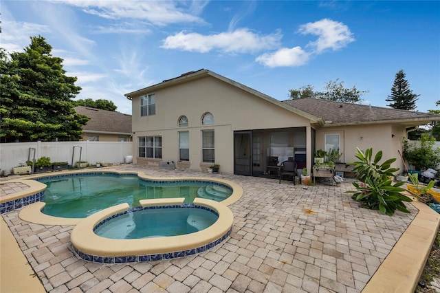 view of swimming pool featuring an in ground hot tub and a patio area