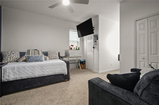 bedroom featuring ceiling fan, a closet, and light carpet