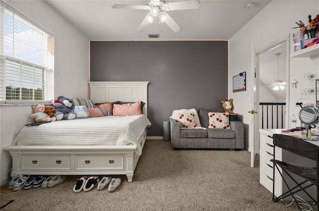 bedroom featuring ceiling fan and carpet