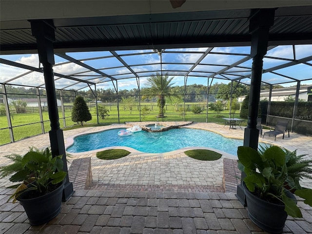 view of pool with a patio area, an in ground hot tub, and a lanai